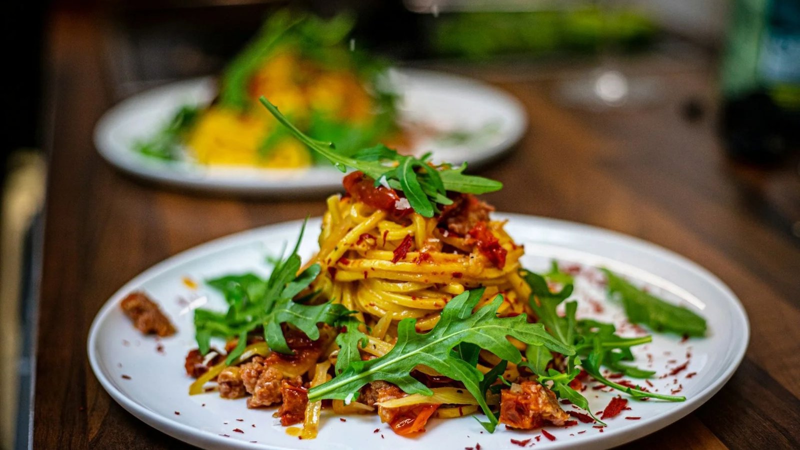 Handmade pasta plated with fresh rocket